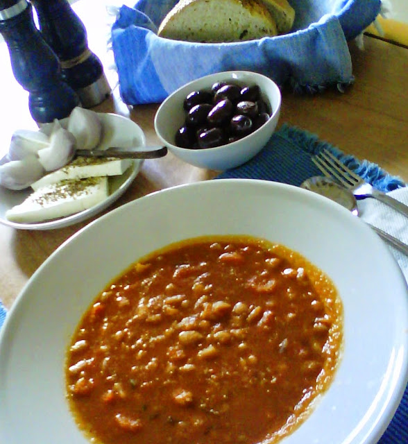 Fasolada with Kalamata olives, feta cheese and raw onion.
